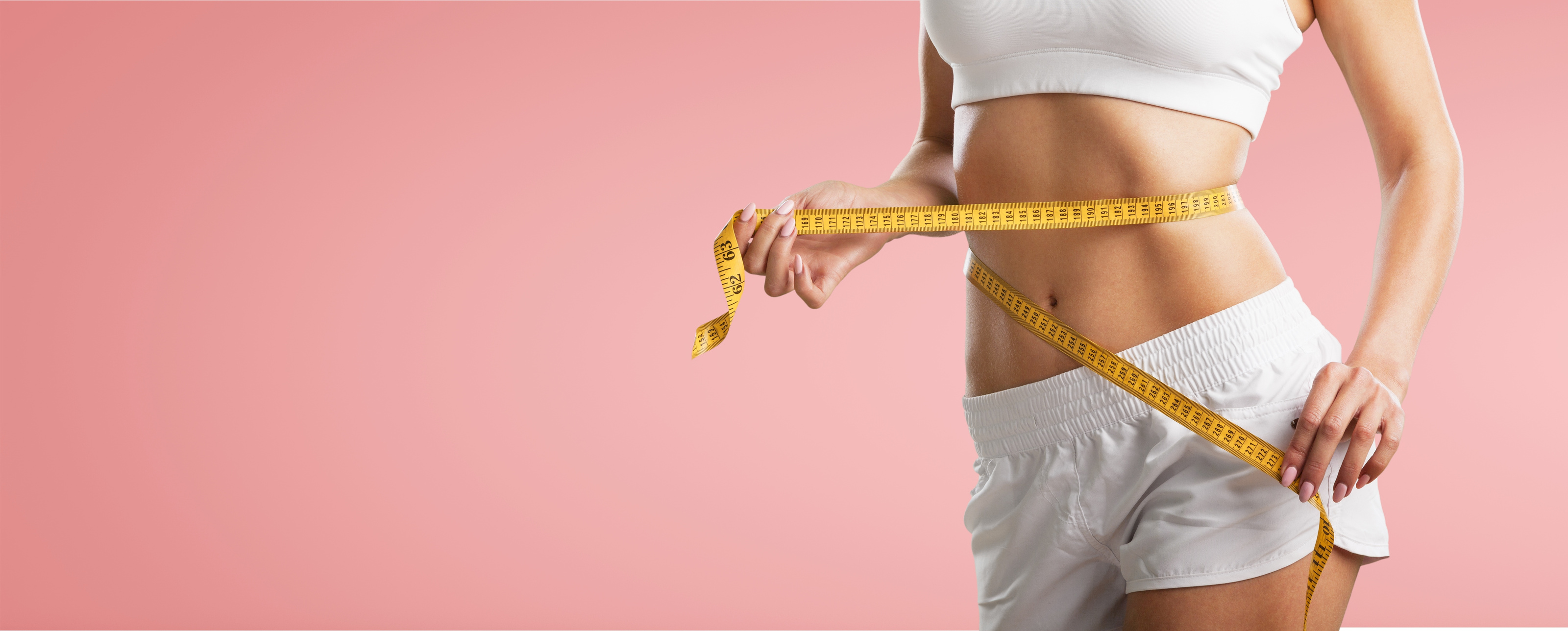 Woman Measuring Waist with a Measuring Tape 