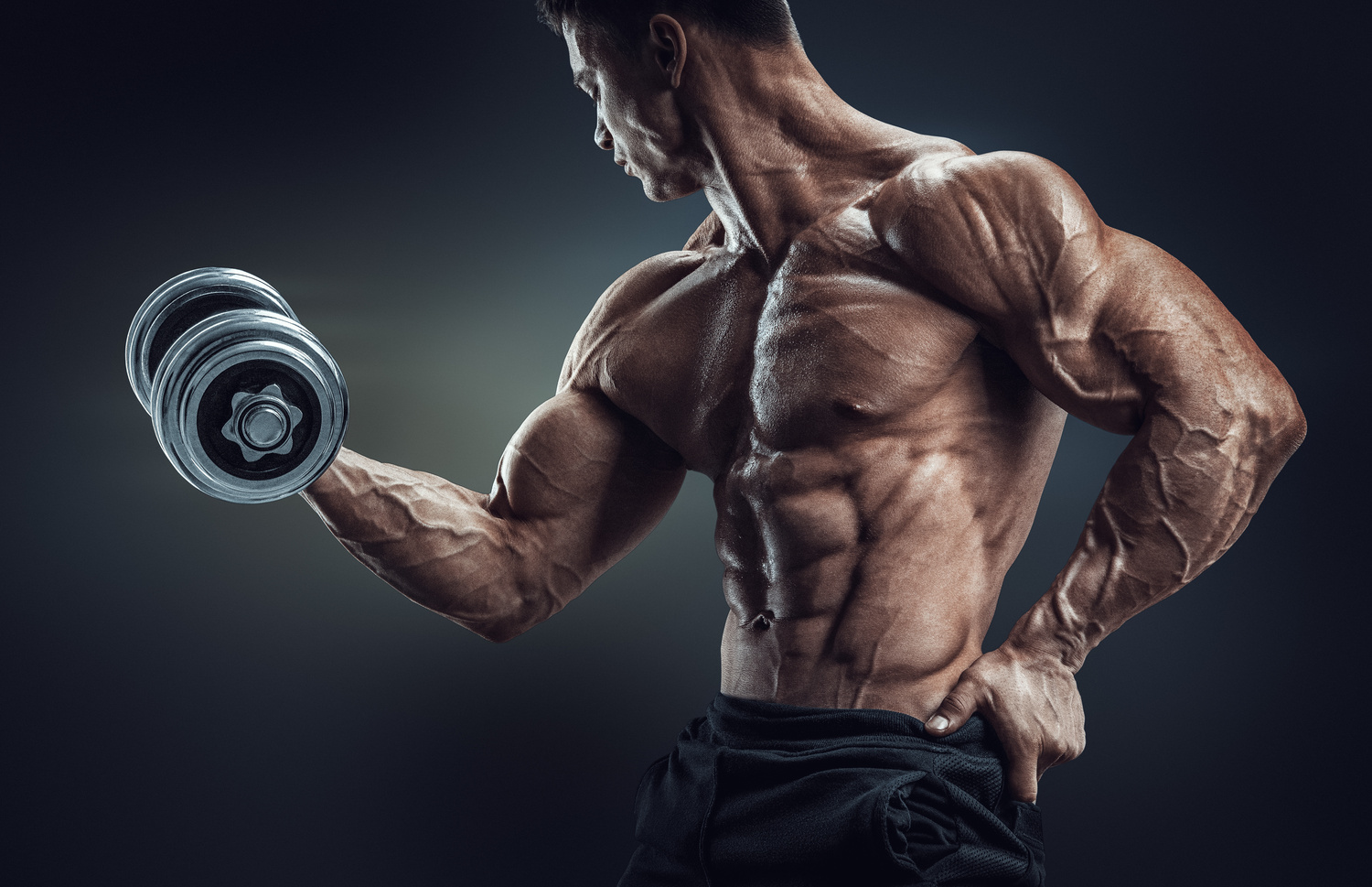 Strong and power bodybuilder doing exercises with dumbbell