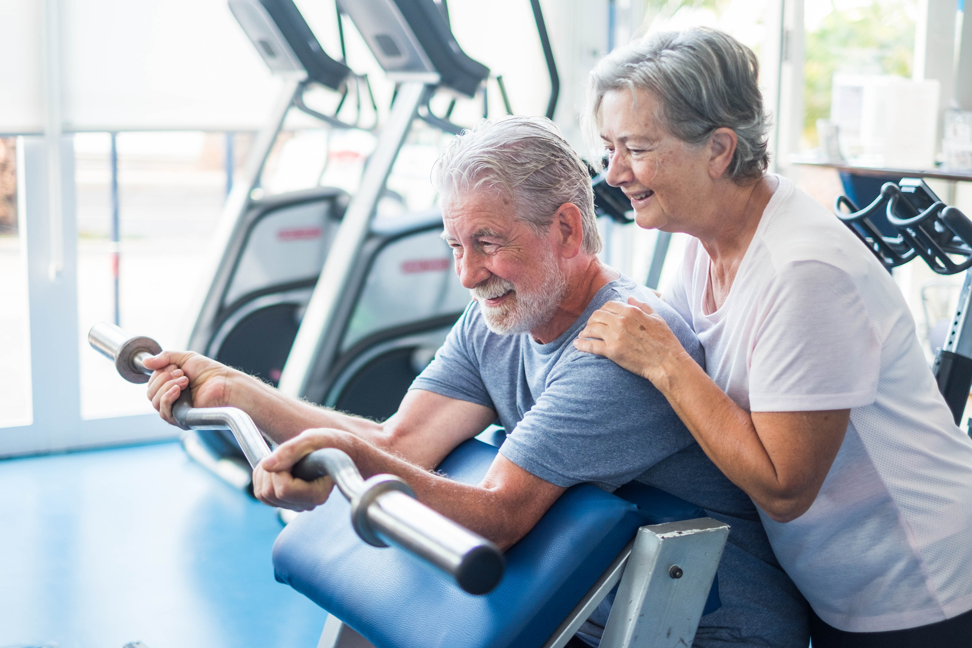 Beautiful Couple of Seniors at the Gym Doing Exercises